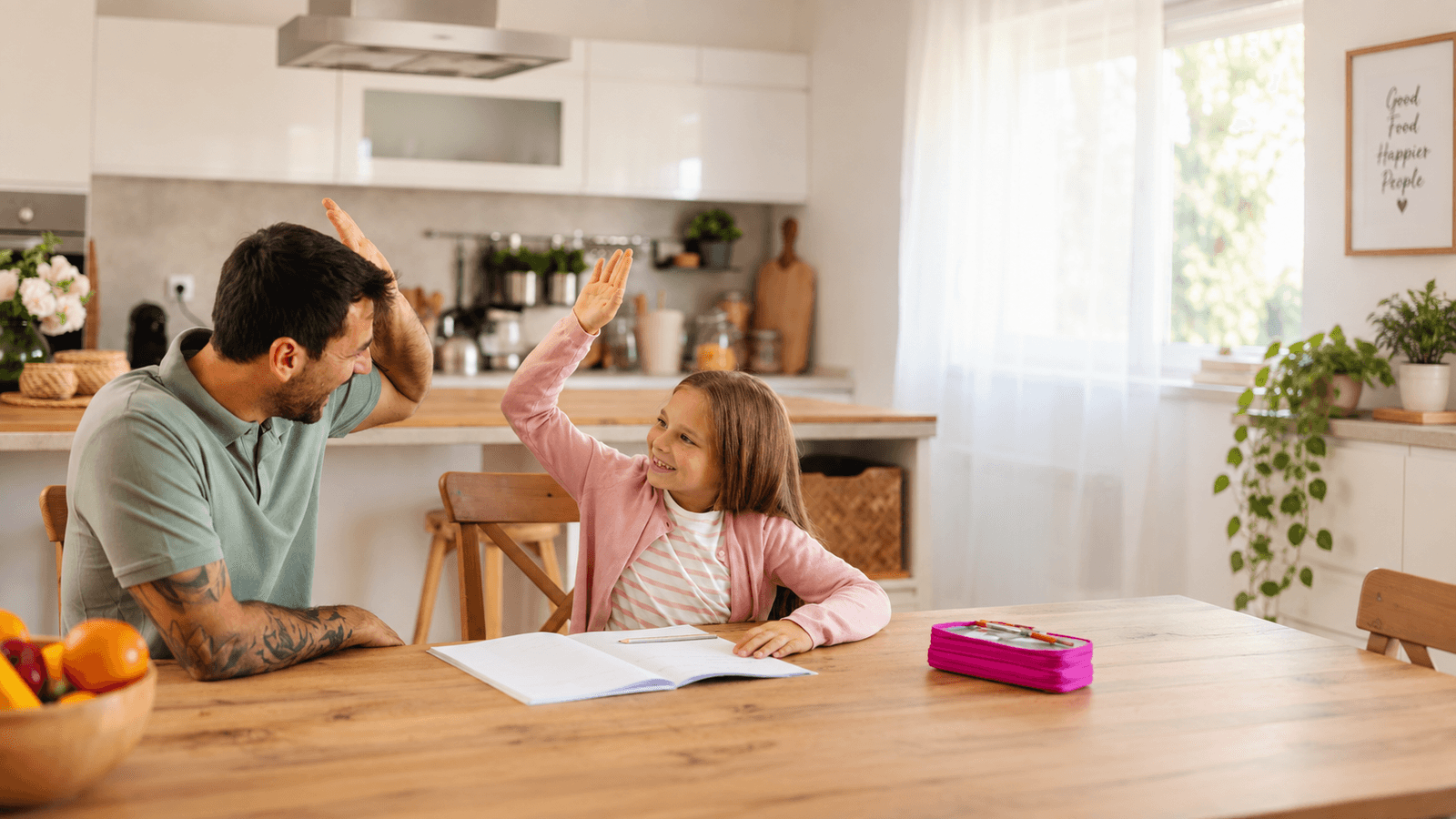 Man and child high-fiving over homework