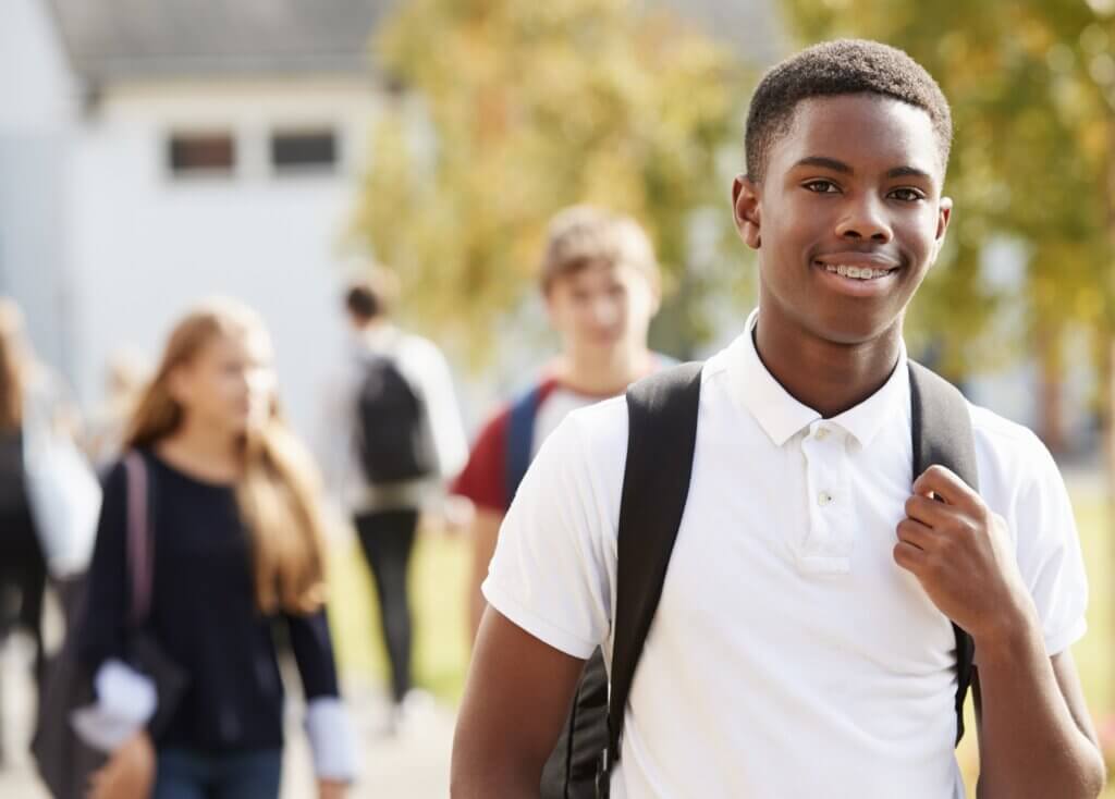 Portrait Of Male Teenage Student Walking Around College Campus